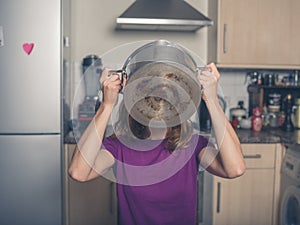 Young woman drinking from pot in kitchen