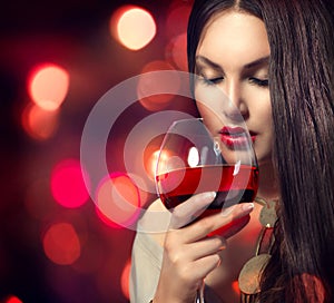 Young woman drinking red wine