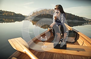 Young woman drinking red wine on the canoe and enjoy outdoors