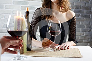 Young woman drinking red wine on a date in a restaurant