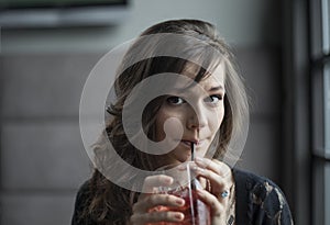 Young Woman Drinking a Shirley Temple photo