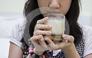 Young woman drinking soybean milk