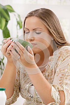 Young woman drinking tea