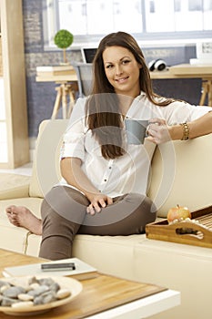 Young woman drinking tea at home