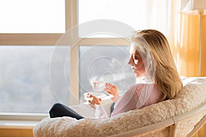 Woman drinking tea while relaxing at home