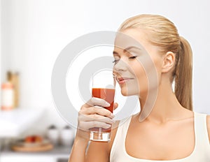 Young woman drinking tomato juice