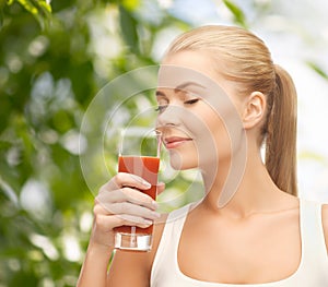 Young woman drinking tomato juice