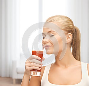 Young woman drinking tomato juice