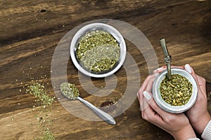 Young woman drinking traditional Argentinian yerba mate tea.