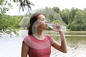 Young woman drinking water.