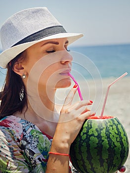 Young woman drinking watermelon cocktail