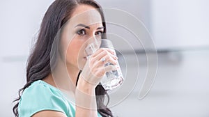 young woman drinks clean water adheres to drinking regime