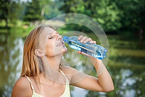 Young woman drinks a water