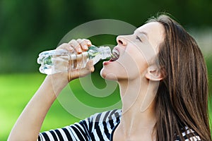 Young woman drinks water bottle