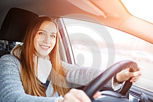 Young woman drive a car in winter