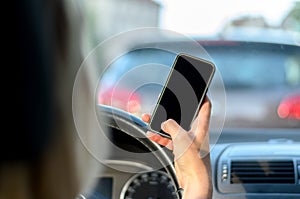 Young woman driver reading a text message