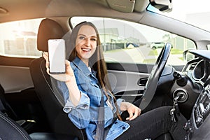 A young woman is driving a car