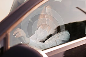 Young woman driving a car in the city. Portrait of a beautiful business woman in a car. Business concept