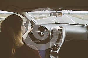 Young woman driving car on highway.