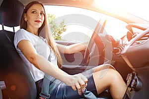 Young woman driving a car on the road