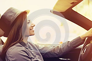 Young woman driving a convertible car