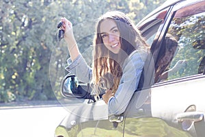 Young woman driving her car. Attractive young girl driver in new car . . girl bought a car.