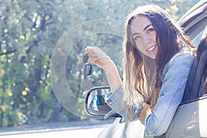 Young woman driving her car. Attractive young girl driver in new car . girl bought a car.