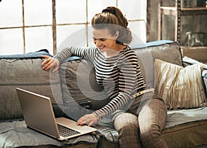 Young woman with dslr photo camera using laptop