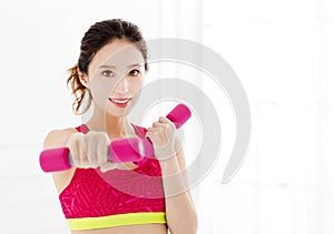 Young woman with dumbbells working out