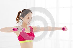 Young woman with dumbbells working out