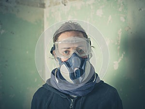 Young woman with dust mask and goggles