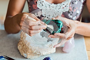 Young woman dusting a malachite