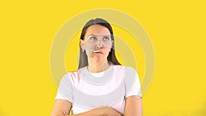 Young woman eagerly sucks a lollipop. Yellow background People sincere emotions concept of sweet tooth