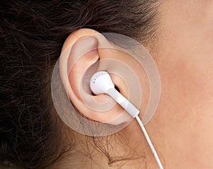 Young woman ear with earphone photo