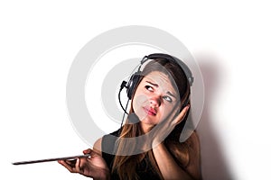 Young woman in earphones and microphone with tablet, isolated