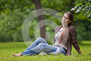 Young woman with earphones in the park.