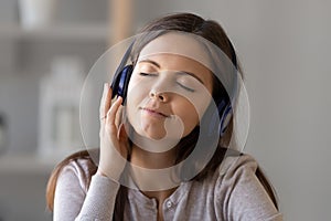 Young woman in earphones relax listening to music