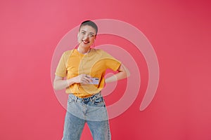 Young woman in earphones smiling and using mobile phone