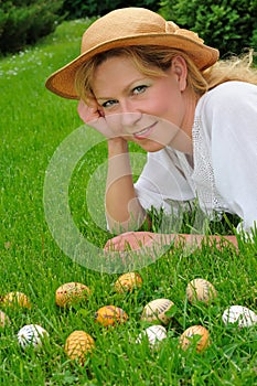 Young woman and easter eggs on the grass - Easter