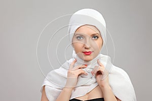 Young woman eastern type in the modern Muslim clothes and beautiful headdress