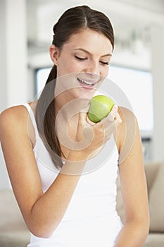 Young Woman Eating An Apple