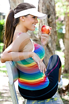 Young Woman Eating Apple on Park Bench