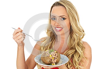 Young Woman Eating a Baked Potato with Tuna and Sweetcorn