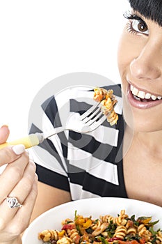 Young Woman Eating A Bowl of Colourful Vegetarian Tomato Pasta