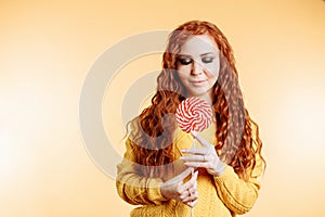 Young woman eating candy lollipop