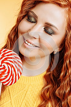 Young woman eating candy lollipop