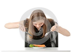 Young woman eating carrot