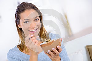 young woman eating cereals