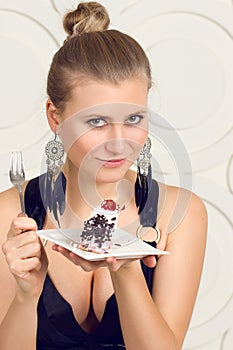 Young woman eating chocolate cake