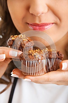 Young woman eating chocolate muffin